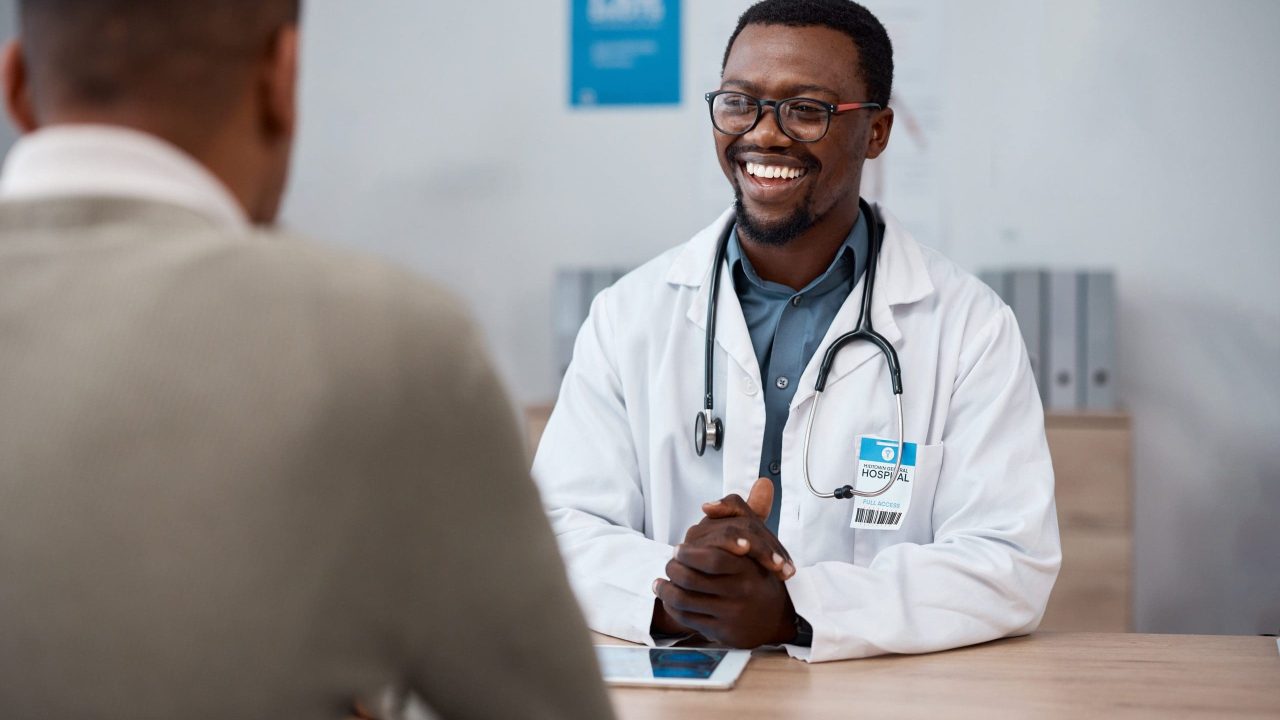 Black man doctor with patient in consultation office for healthcare advice, services and profession